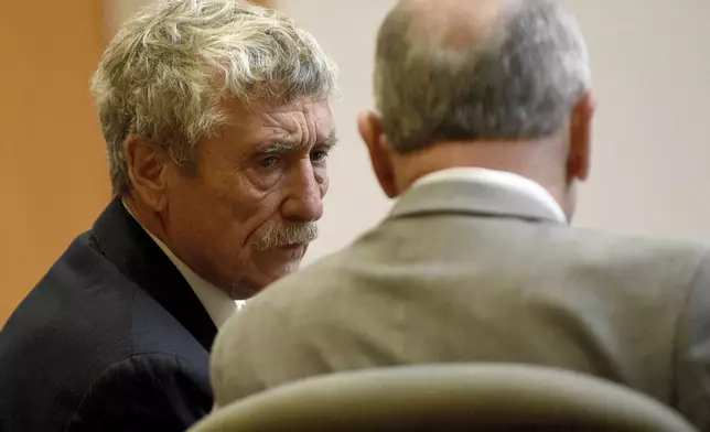 Defendant Bradley Asbury, left, accused of holding down a teenage boy so colleagues could rape him at a New Hampshire youth center in the 1990s, confers with his attorney David Rothstein during opening statements for his trial at Hillsborough County Superior Court in Manchester, N.H.,, Tuesday, Nov. 19, 2024. (David Lane/Union Leader via AP, Pool)