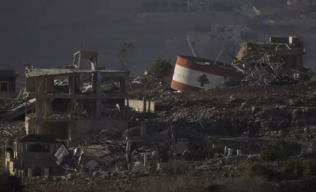 Destroyed buildings stand on an area of a village in southern Lebanon as seen from northern Israel, Monday, Nov. 25, 2024. (AP Photo/Leo Correa)