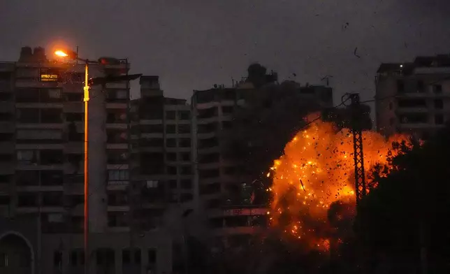 Thick smoke and flames erupt from an Israeli airstrike in Tayouneh, Beirut, Lebanon, Monday, Nov. 25, 2024. (AP Photo/Hassan Ammar)