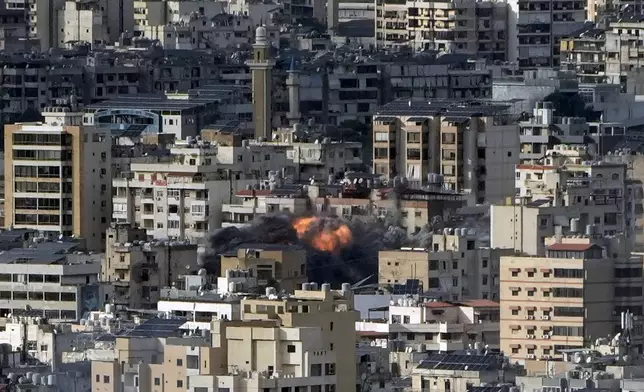 Smoke and flame rise after an Israeli airstrike on Dahiyeh, in Beirut, Lebanon, Monday, Nov. 25, 2024. (AP Photo/Bilal Hussein)