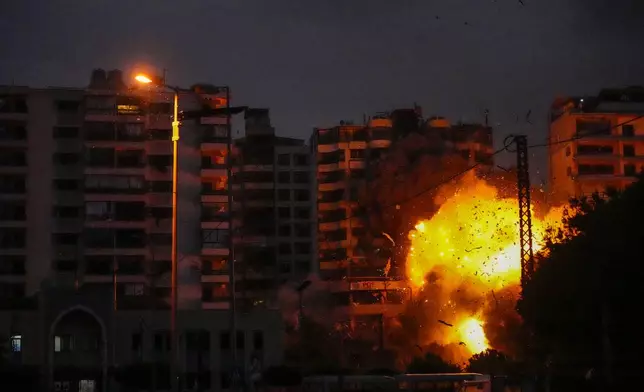 Smoke and flames erupt from an Israeli airstrike that targeted a building in Tayouneh, Beirut, Lebanon, Monday, Nov. 25, 2024. (AP Photo/Hassan Ammar)