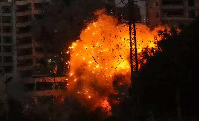 Flames and debris erupt from an Israeli airstrike that targeted a building in Tayouneh, Beirut, Lebanon, Monday, Nov. 25, 2024. (AP Photo/Hassan Ammar)