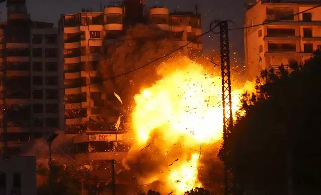 Thick smoke and flames erupt from an Israeli airstrike in Tayouneh, Beirut, Lebanon, Monday, Nov. 25, 2024. (AP Photo/Hassan Ammar)