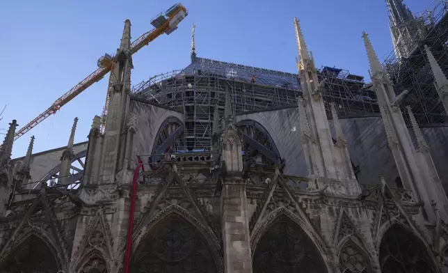 A workers walks on scaffolding at Notre-Dame cathedral, Thursday, Nov. 28, 2024 in Paris. (AP Photo/Michel Euler)