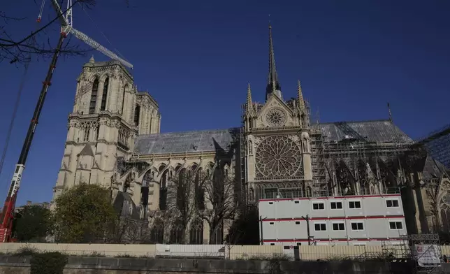 Cranes and workers' facilities are seen along Notre-Dame cathedral, Thursday, Nov. 28, 2024 in Paris. (AP Photo/Michel Euler)