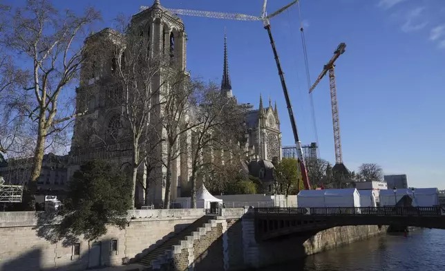 Cranes are seen by Notre-Dame cathedral, Thursday, Nov. 28, 2024 in Paris. (AP Photo/Michel Euler)