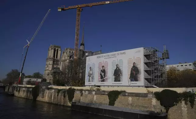 Cranes and workers' facilities are seen behind Notre-Dame cathedral, Thursday, Nov. 28, 2024 in Paris. (AP Photo/Michel Euler)