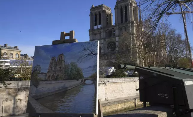 A painting showing Notre-Dame cathedral is seen along the Seine river bank, Thursday, Nov. 28, 2024 in Paris. (AP Photo/Michel Euler)