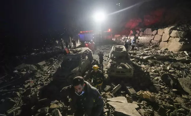 FILE - Rescuers search for survivors after an Israeli airstrike in Baalchmay village east of Beirut, Lebanon, on Nov. 12, 2024. (AP Photo/Hassan Ammar, File)