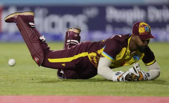 West Indies' wicket keeper Shai Hope drops a catch from the bat of England's Liam Livingstone during the third T20 cricket match at Daren Sammy National Cricket Stadium in Gros Islet, St. Lucia, Thursday, Nov. 14, 2024. (AP Photo/Ricardo Mazalan)