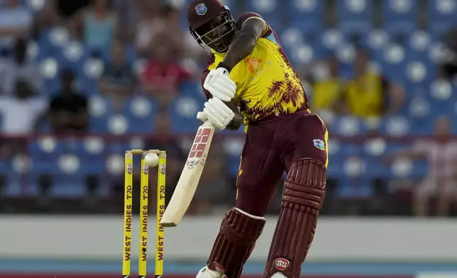 West Indies' captain Rovman Powell plays a shot for six runs from a delivery of England's Jofra Archer during the third T20 cricket match at Daren Sammy National Cricket Stadium in Gros Islet, St.Lucia, Thursday, Nov. 14, 2024. (AP Photo/Ricardo Mazalan)