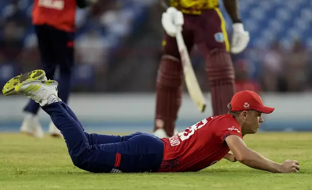 England's Sam Curran fields against West Indies during the third T20 cricket match at Daren Sammy National Cricket Stadium in Gros Islet, St.Lucia, Thursday, Nov. 14, 2024. (AP Photo/Ricardo Mazalan)