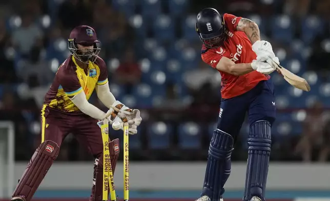 England's Phil Salt is bowled by West Indies' Akeal Hosein during the third T20 cricket match at Daren Sammy National Cricket Stadium in Gros Islet, St. Lucia, Thursday, Nov. 14, 2024. (AP Photo/Ricardo Mazalan)