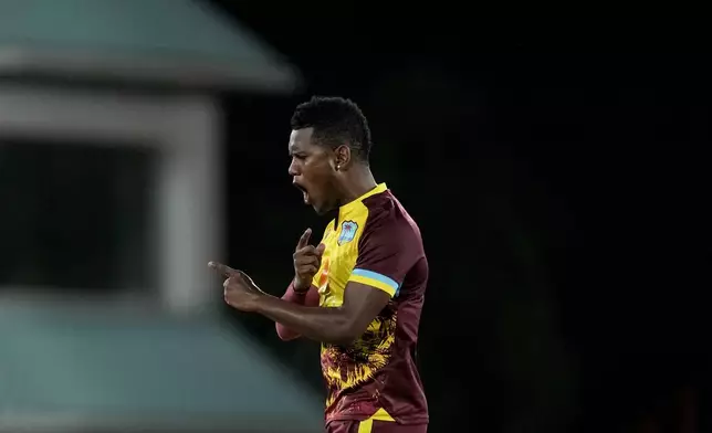 West Indies' Akeal Hosein celebrates taking the wicket of England's Phil Salt during the third T20 cricket match at Daren Sammy National Cricket Stadium in Gros Islet, St. Lucia, Thursday, Nov. 14, 2024. (AP Photo/Ricardo Mazalan)