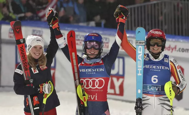 From left, second placed Austria's Katharina Liensberger, the winner United States' Mikaela Shiffrin and third placed Germany's Lena Duerr celebrate after an alpine ski, women's World Cup slalom, in Levi, Finland, Saturday, Nov. 16, 2024. (AP Photo/Marco Trovati)