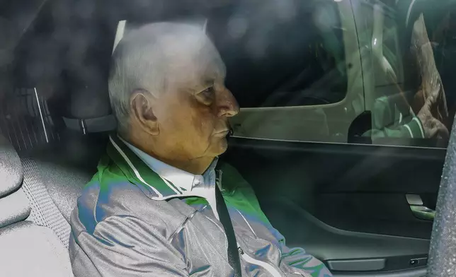 Retired Sydney broadcaster and former Australian national rugby coach Alan Jones is seen in the back of an unmarked police car as he is transferred to Day St Police Station in Sydney, Monday, Nov. 18, 2024. (Bianca De Marchi/AAP Image via AP)