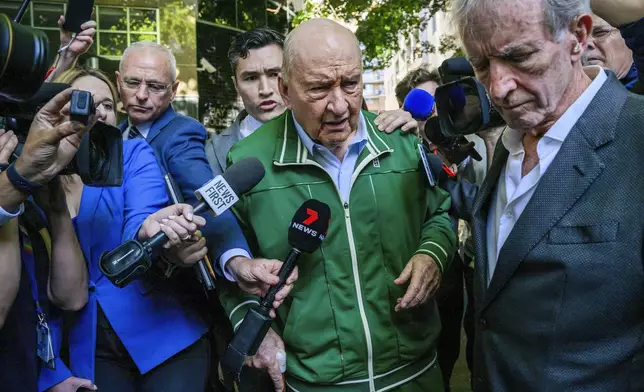 Retired Sydney broadcaster and former Australian national rugby coach Alan Jones, centre, walks past waiting media as he leaves a police station in Sydney, Monday, Nov. 18, 2024. (Bianca De Marchi/AAP Image via AP)