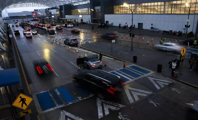 Travelers arrive at Hartsfield-Jackson Atlanta International Airport, Tuesday, Nov. 26, 2024, in Atlanta. (AP Photo/Olivia Bowdoin)