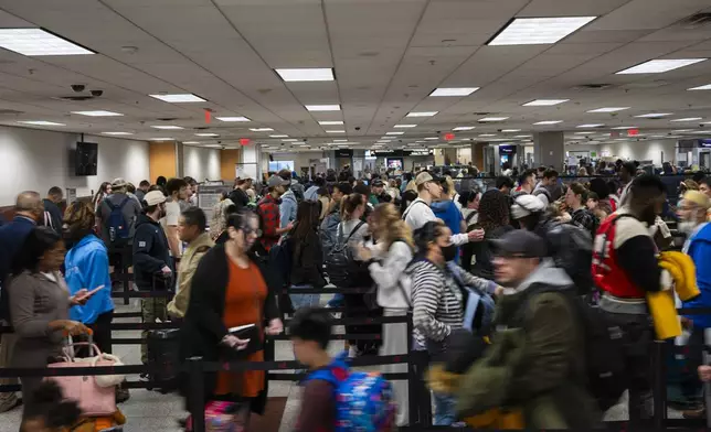 Travelers rush to their gate at Hartsfield-Jackson Atlanta International Airport, Tuesday, Nov. 26, 2024, in Atlanta. (AP Photo/Olivia Bowdoin)