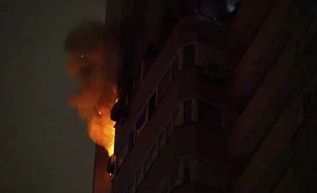 Flames and smoke rise from a residential building after the attack of Russian drones in Kyiv, Ukraine, Friday, Oct. 26, 2024. (AP Photo/Alex Babenko)