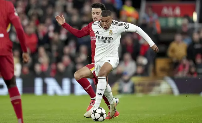 Real Madrid's Kylian Mbappe, right, vies for the ball with Liverpool's Curtis Jones during the Champions League opening phase soccer match between Liverpool and Real Madrid at Anfield Stadium, Liverpool, England, Wednesday, Nov. 27, 2024. (AP Photo/Jon Super)