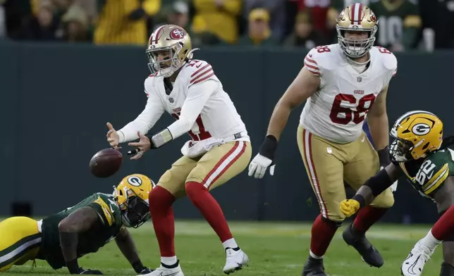 San Francisco 49ers quarterback Brandon Allen (17) fumbles and recovers the ball during the first half of an NFL football game against the Green Bay Packers on Sunday, Nov. 24, 2024 in Green Bay, Wis. (AP Photo/Matt Ludtke)