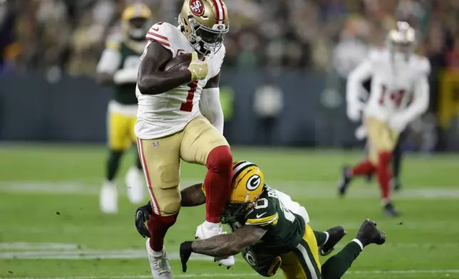 San Francisco 49ers wide receiver Deebo Samuel Sr. (1) avoids the tackle against Green Bay Packers safety Javon Bullard (20) during the first half of an NFL football game on Sunday, Nov. 24, 2024 in Green Bay, Wis. (AP Photo/Matt Ludtke)