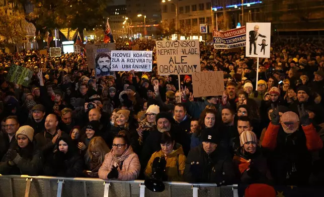 Thousands of protesters gather to mark the 35th anniversary of the Velvet Revolution, that brought an end to decades of communist rule in Czechoslovakia, and to oppose the policies of populist Prime Minister Robert Fico, in Bratislava, Slovakia, Sunday, Nov. 17, 2024. (AP Photo/Petr David Josek)