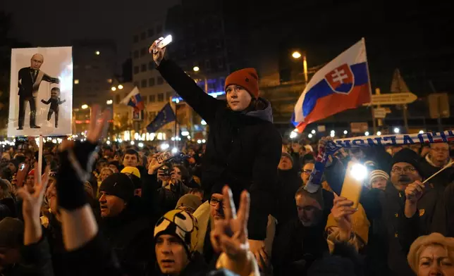 Thousands of protesters gather to mark the 35th anniversary of the Velvet Revolution, that brought an end to decades of communist rule in Czechoslovakia, and to oppose the policies of populist Prime Minister Robert Fico, in Bratislava, Slovakia, Sunday, Nov. 17, 2024. (AP Photo/Petr David Josek)