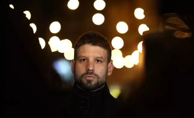 Leader of Progressive Slovakia party Michal Simecka speaks to the media as thousands of protesters gather to mark the 35th anniversary of the Velvet Revolution, that brought an end to decades of communist rule in Czechoslovakia, and to oppose the policies of populist Prime Minister Robert Fico, in Bratislava, Slovakia, Sunday, Nov. 17, 2024. (AP Photo/Petr David Josek)