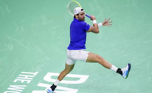 Italy's Matteo Berrettini returns the ball against Australia's Thanasi Kokkinakis during the Davis Cup semifinal at the Martin Carpena Sports Hall in Malaga, southern Spain, on Saturday, Nov. 23, 2024. (AP Photo/Manu Fernandez)