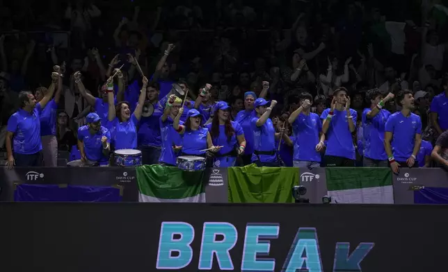 Supporters of Italy cheer during the match between Italy's Matteo Berrettini and Australia's Thanasi Kokkinakis during the Davis Cup semifinal at the Martin Carpena Sports Hall in Malaga, southern Spain, on Saturday, Nov. 23, 2024. (AP Photo/Manu Fernandez)