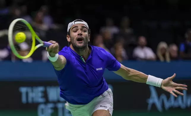 Italy's Matteo Berrettini returns the ball against Australia's Thanasi Kokkinakis during the Davis Cup semifinal at the Martin Carpena Sports Hall in Malaga, southern Spain, on Saturday, Nov. 23, 2024. (AP Photo/Manu Fernandez)