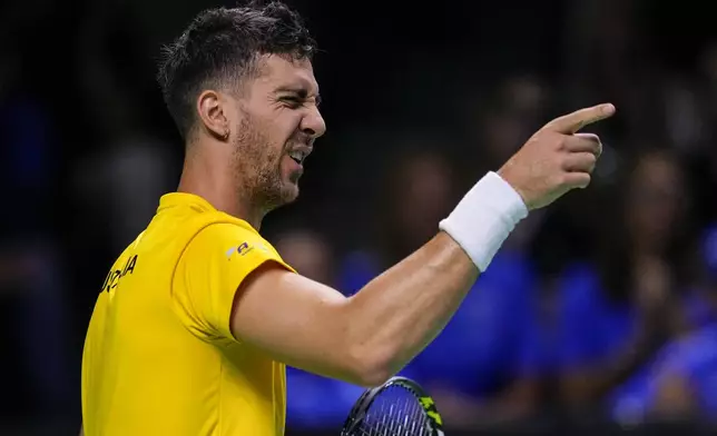 Australia's Thanasi Kokkinakis gestures during his match against Italy's Matteo Berrettini during the Davis Cup semifinal at the Martin Carpena Sports Hall in Malaga, southern Spain, on Saturday, Nov. 23, 2024. (AP Photo/Manu Fernandez)