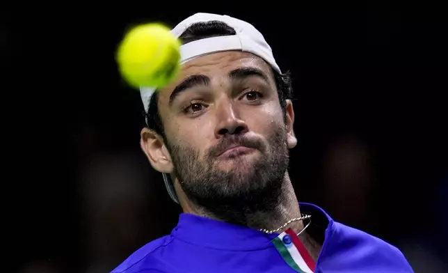 Italy's Matteo Berrettini eyes the ball during his match against Australia's Thanasi Kokkinakis during the Davis Cup semifinal at the Martin Carpena Sports Hall in Malaga, southern Spain, on Saturday, Nov. 23, 2024. (AP Photo/Manu Fernandez)