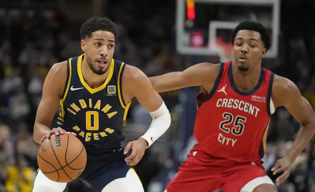 Indiana Pacers' Tyrese Haliburton (0) goes to the basket against New Orleans Pelicans' Trey Murphy III (25) during the first half of an NBA basketball game, Monday, Nov. 25, 2024, in Indianapolis. (AP Photo/Darron Cummings)