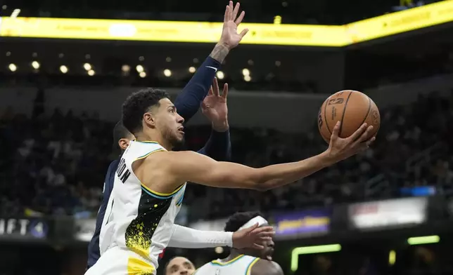 Indiana Pacers' Tyrese Haliburton puts up a shot against Washington Wizards' Kyle Kuzma during the second half of an NBA basketball game, Sunday, Nov. 24, 2024, in Indianapolis. (AP Photo/Darron Cummings)