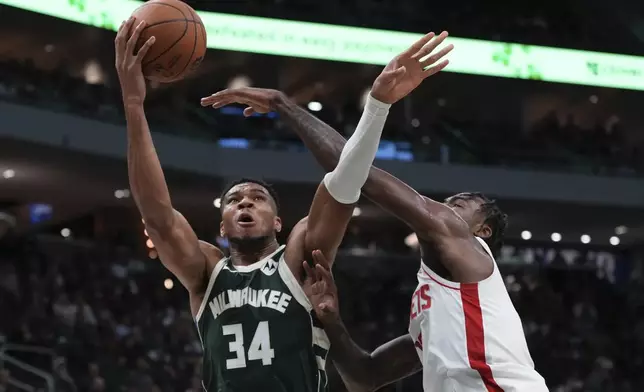 Milwaukee Bucks' Giannis Antetokounmpo shoots past Houston Rockets' Tari Eason during the first half of an NBA basketball game Monday, Nov. 18, 2024, in Milwaukee. (AP Photo/Morry Gash)