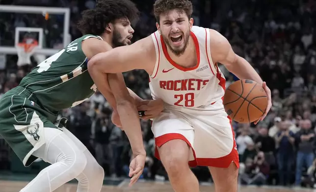 Houston Rockets' Alperen Sengun tries to get p-ast Milwaukee Bucks' Andre Jackson Jr. during the second half of an NBA basketball game Monday, Nov. 18, 2024, in Milwaukee. The Bucks won 101-100. (AP Photo/Morry Gash)