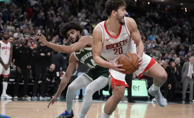 Houston Rockets' Alperen Sengun and Milwaukee Bucks' Andre Jackson Jr. go after the ball during the second half of an NBA basketball game Monday, Nov. 18, 2024, in Milwaukee. The Bucks won 101-100. (AP Photo/Morry Gash)