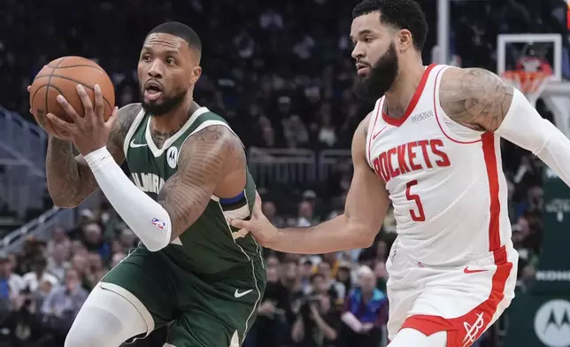 Milwaukee Bucks' Damian Lillard gets past Houston Rockets' Fred VanVleetduring the first half of an NBA basketball game Monday, Nov. 18, 2024, in Milwaukee. (AP Photo/Morry Gash)