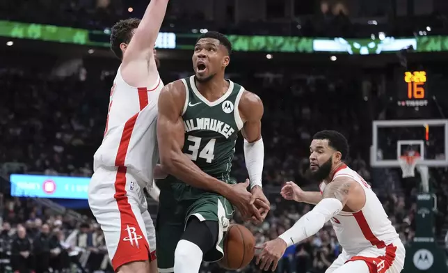 Houston Rockets' Fred VanVleet knocks the ball from Milwaukee Bucks' Giannis Antetokounmpo during the first half of an NBA basketball game Monday, Nov. 18, 2024, in Milwaukee. (AP Photo/Morry Gash)