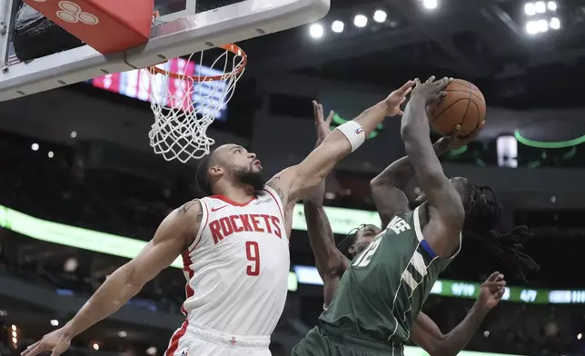 Milwaukee Bucks' Taurean Prince is fouled by Houston Rockets' Dillon Brooks during the first half of an NBA basketball game Monday, Nov. 18, 2024, in Milwaukee. (AP Photo/Morry Gash)