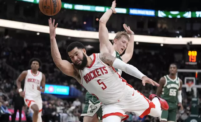 Houston Rockets' Fred VanVleet is fouled by Milwaukee Bucks' AJ Green as he shoots during the second half of an NBA basketball game Monday, Nov. 18, 2024, in Milwaukee. The Bucks won 101-100. (AP Photo/Morry Gash)