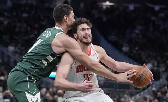 Milwaukee Bucks' Brook Lopez knocks the ball from Houston Rockets' Alperen Sengun during the second half of an NBA basketball game Monday, Nov. 18, 2024, in Milwaukee. The Bucks won 101-100. (AP Photo/Morry Gash)