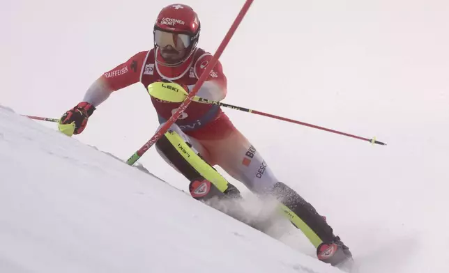 Switzerland's Loic Meillard speeds down the course during an alpine ski, men's World Cup slalom, in Levi, Finland, Sunday, Nov. 17, 2024. (AP Photo/Marco Trovati)