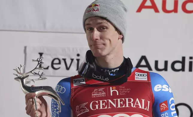The winner France's Clement Noel celebrates on podium after an alpine ski, men's World Cup slalom, in Levi, Finland, Sunday, Nov. 17, 2024. (AP Photo/Marco Trovati)