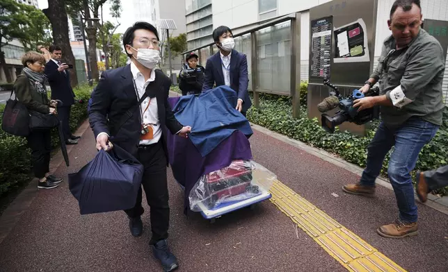 Prosecutors with the evidence head to the Chiba District Court on the opening day of the trial over Australian citizen Donna Nelson for allegedly attempting to import drugs into Japan Monday, Nov. 18, 2024, in Chiba, east of Tokyo. (AP Photo/Eugene Hoshiko)