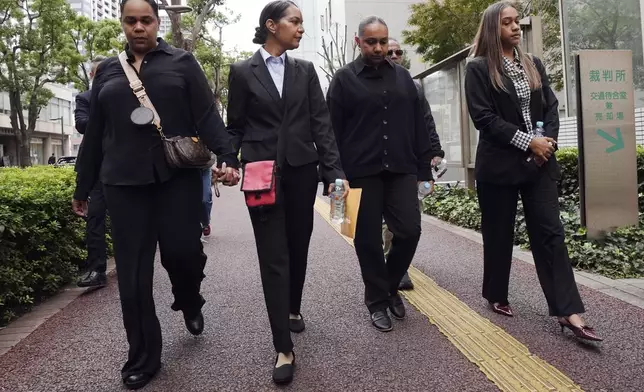 Family members of Australian citizen Donna Nelson head to the Chiba District Court on the opening day of the trial over Nelson for allegedly attempting to import drugs into Japan Monday, Nov. 18, 2024, in Chiba, east of Tokyo. (AP Photo/Eugene Hoshiko)