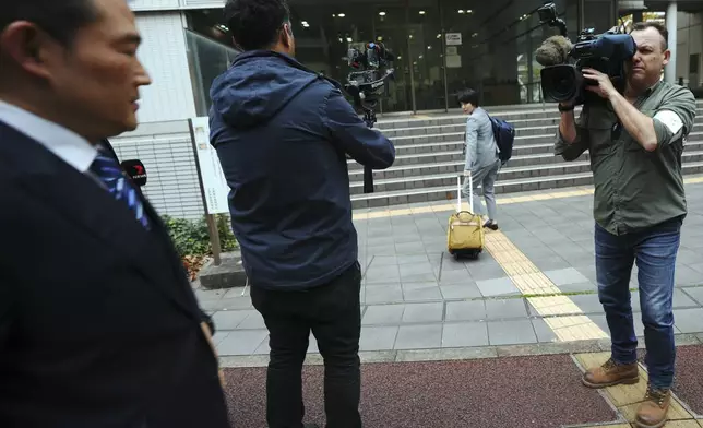 Japanese lawyer Rie Nishida, center, enters to the Chiba District Court on the opening day of the trial over Indigenous community leader Donna Nelson for allegedly attempting to import drugs into Japan Monday, Nov. 18, 2024, in Tokyo. (AP Photo/Eugene Hoshiko)